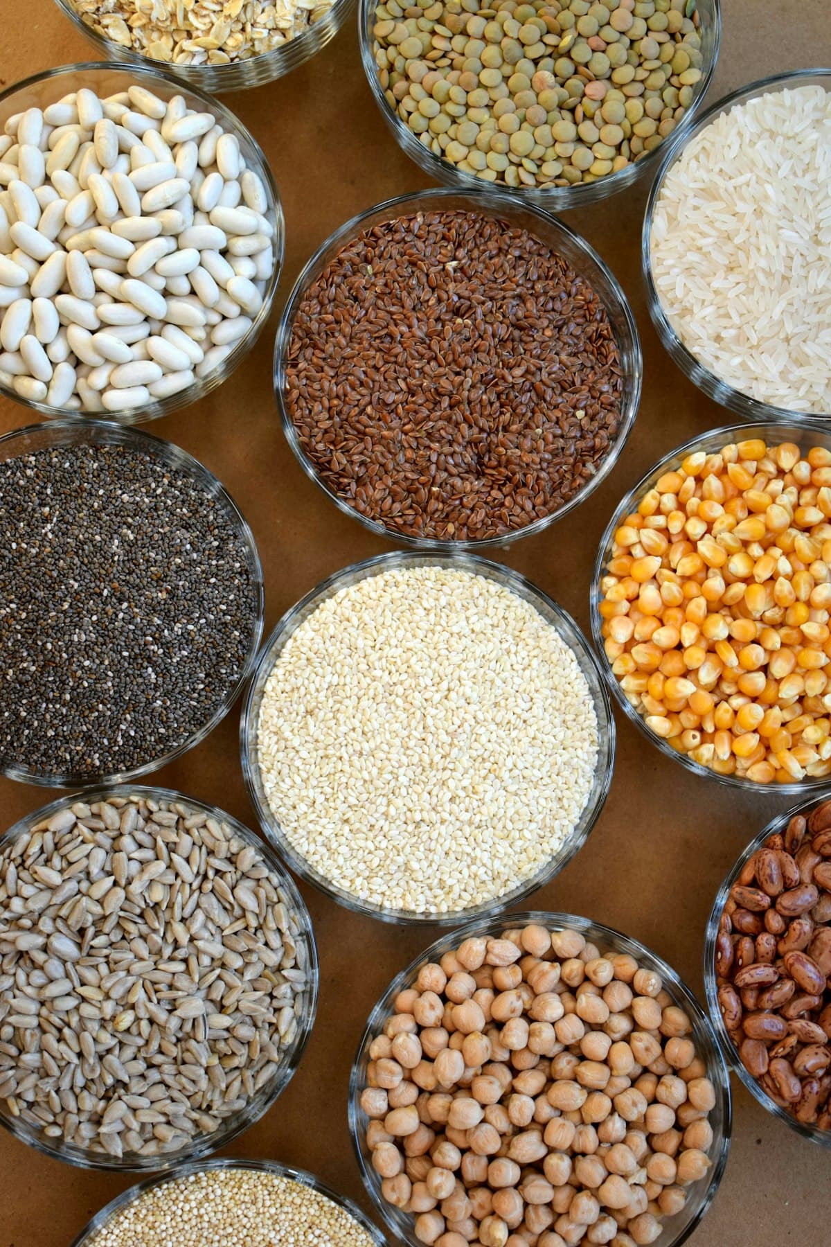 Glass bowls holding assorted grains, seeds, rice and pulses
